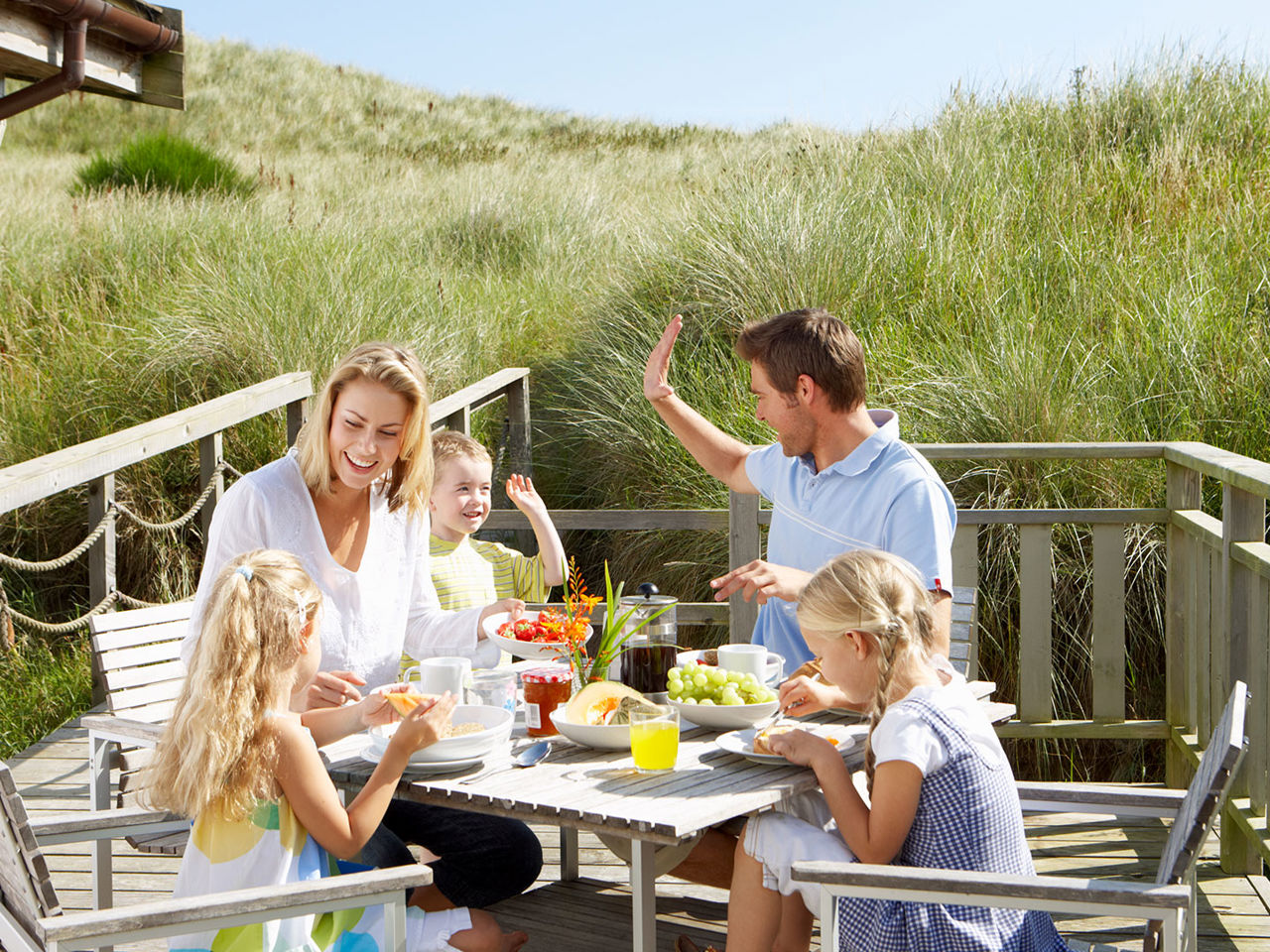 Familie der spiser udendørs i deres sommerferie